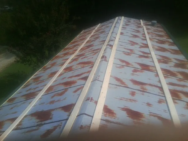 Rusted metal roof panels with new wood purlins before replacement — Storm Damage Roof Repair in Mercersburg by Roofing Brothers