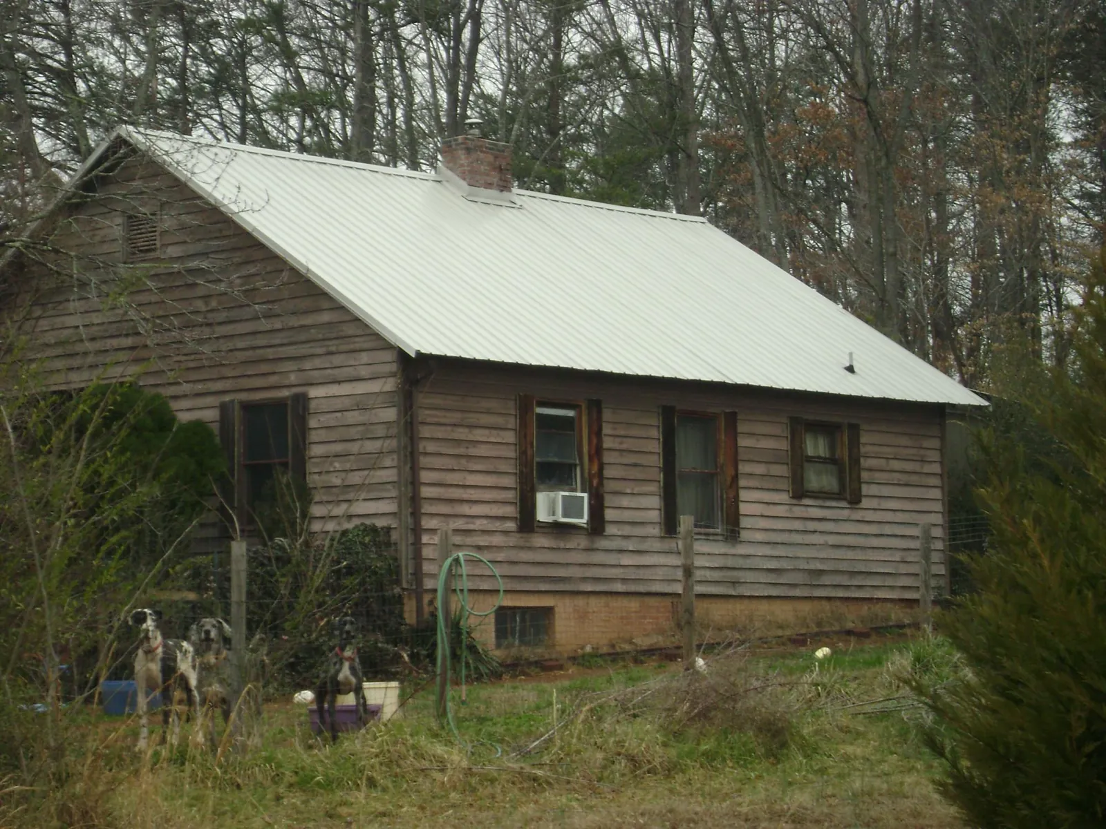 White metal roof on an old wood sided farmhouse, from a Metal Roof Installation job in Mercersburg